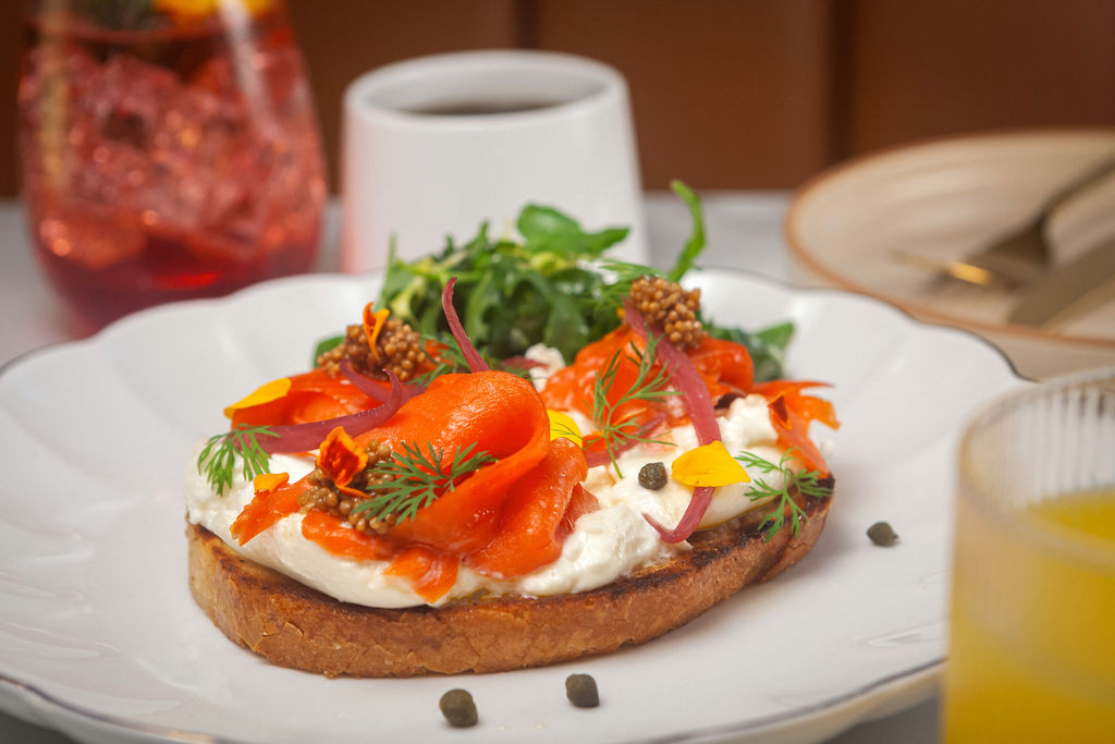Smoked salmon toast with cream cheese, capers and edible flowers